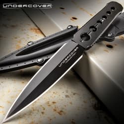Black dagger with sheath on rusty metal surface