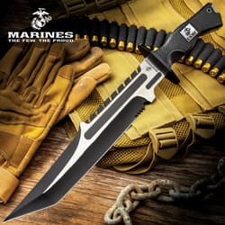 Large knife with silver and black accents of both the blade and the handle with an overall tactical styling on a background of military gear.