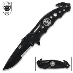 Black folding knife with skull logo and serrated blade