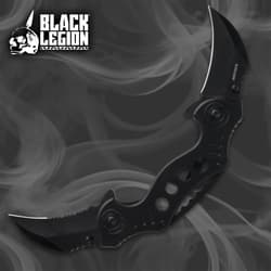 Black folding knife with dual blades on smoky background