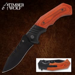 Folding knife with wooden handle on brown background