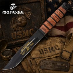 USMC knife with engraved blade on a military-themed background