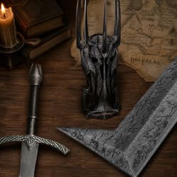 Medieval helmet, sword, and map on wooden table