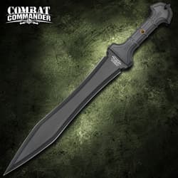 Single black tactical knife with a textured handle on a green background