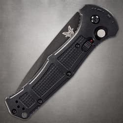 Closed black folding knife with textured grip