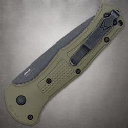 Closed olive drab knife with clip on textured handle
