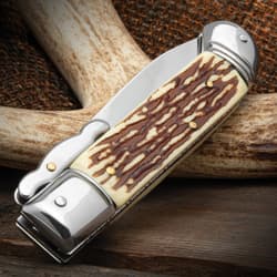 A close-up of the faux stag handle of the pocket knife