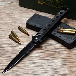 Knife with bullets and magazines on wood