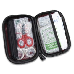 It includes assorted sizes of bandages and dressings, adhesive tape, alcohol prep pads, sting relief pads, antiseptic towelettes