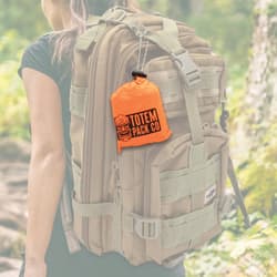 Full image of the Camping Rain Poncho in its carrying bag hanging on a backpack.