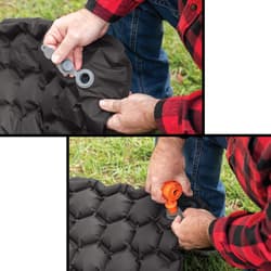 A person inflating the sleeping mat.