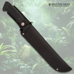 Knife in black sheath against jungle backdrop