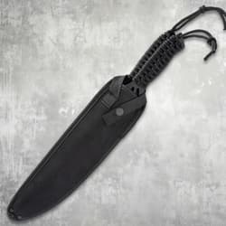 Black machete in a nylon sheath with paracord handle