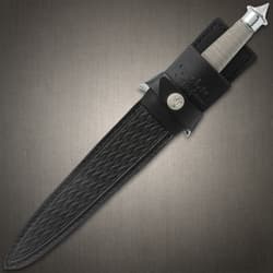 Dagger enclosed in a black leather sheath, the wire wrapped hilt and mirror polished finishes are exposed.
