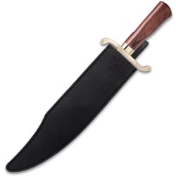 Large bowie knife enclosed in a black leather sheath with an exposed gold handguard and wood handle.