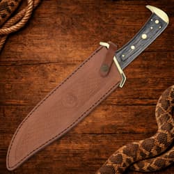 The bowie knife is housed in a handmade genuine leather belt sheath.