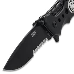 Close-up of black serrated knife blade with logo