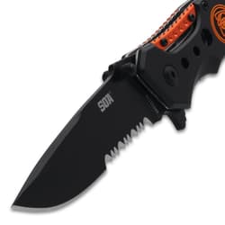 Close-up of black serrated knife blade with logo