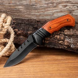 Knife with wooden handle on wood and rope background