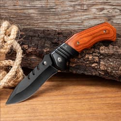 Knife with wooden handle on wood and rope background