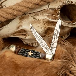 Knife with engraved blades on fur and skull background