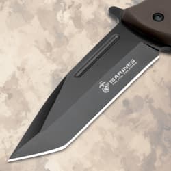 Close-up of black blade with USMC logo