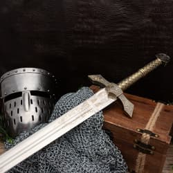 Sword with helmet and chainmail on wooden chest