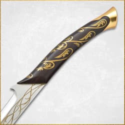 Close-up of sword handle with gold vine design