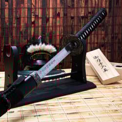 Katana on stand with mask and wooden box in background