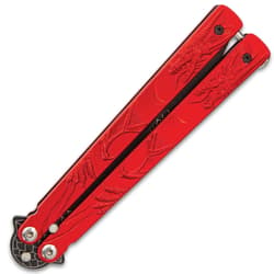 The knife is shown closed with molded red steel handle, secured with latch lock, with ornate dragon design.