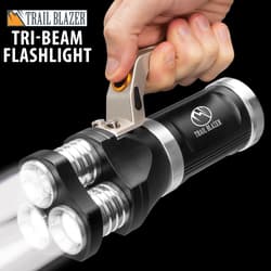 Hand holding a tri-beam flashlight with three bright LED lights