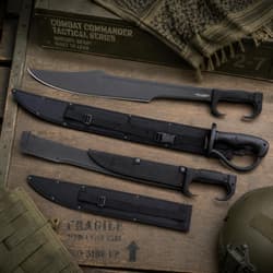 Tactical knives and sheaths on a wooden crate with military gear