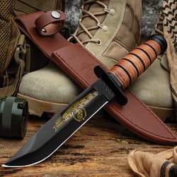 USMC knife with engraved blade, military gear, and cup
