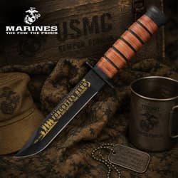 USMC knife with engraved blade, military gear, and cup