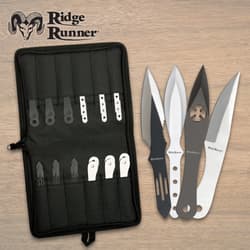 Set of throwing knives with black nylon case on wooden surface