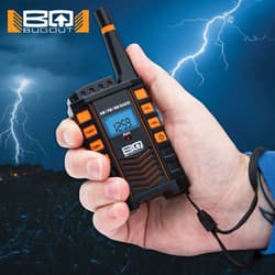 Hand holding a Bugout AM/FM radio with lightning in background