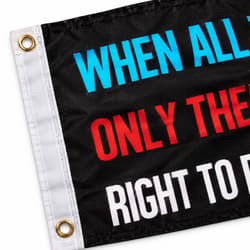Close-up of a black flag with colorful text and metal grommets