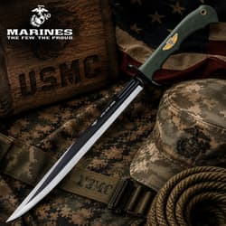 Long tactical knife with green handle on camo fabric and rope