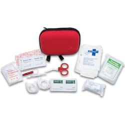 Red first aid kit with medical supplies and scissors
