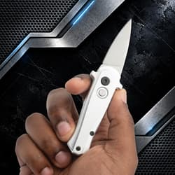 Hand holding a silver automatic knife