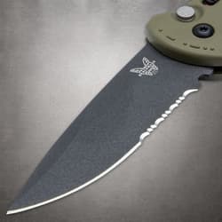 Close-up of serrated knife blade with logo
