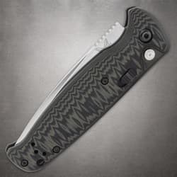 Folded Benchmade knife highlighting handle texture and clip