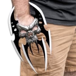 The Skull Reaver Hand Blade shown on someones hand.