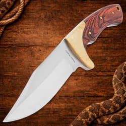Close-up of knife with wood handle on wooden background