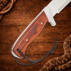 Close-up of machete's wooden handle with lanyard