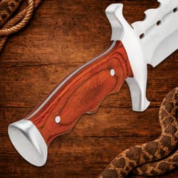 Close-up of wooden handle on a spiked bowie knife