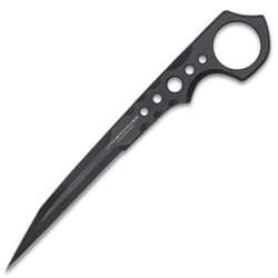 "Undercover" stinger knife being held in front of a black knife sheath attached to a military-style boot.