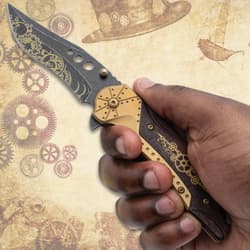Hand holding a steampunk knife with gear design