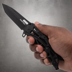 Hand holding a black Rampage folding knife