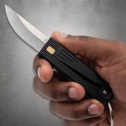 Hand holding a black folding knife with a silver blade